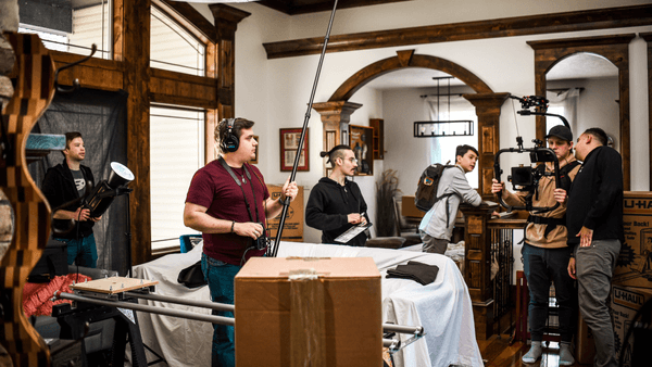 Candid shot of Sean Crone operating a boom microphone on a film location, capturing dialogue for a narrative project.